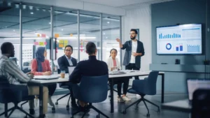 Business team in a modern conference room reviewing data dashboards during a strategy meeting focused on proving PR ROI for B2B tech.