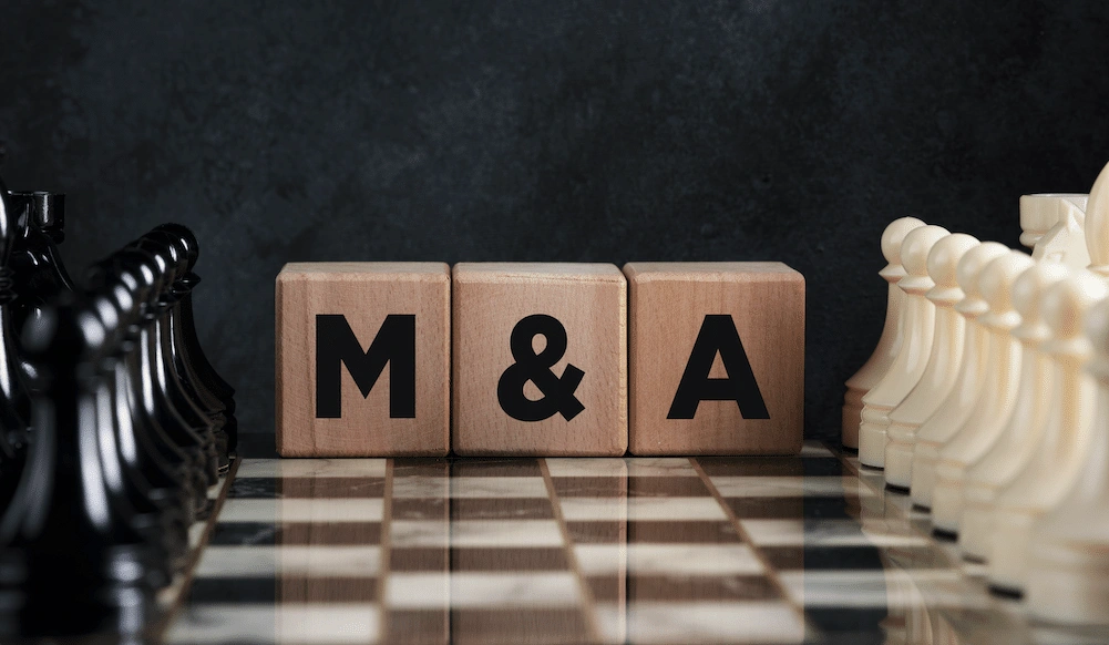 Wooden blocks spelling "M&A" on a chessboard, symbolizing strategic PR for M&A deals and high-stakes corporate negotiations.