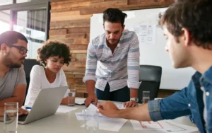 A diverse team of professionals in a modern office collaborating on business strategy, embodying credibility that drives B2B tech growth.
