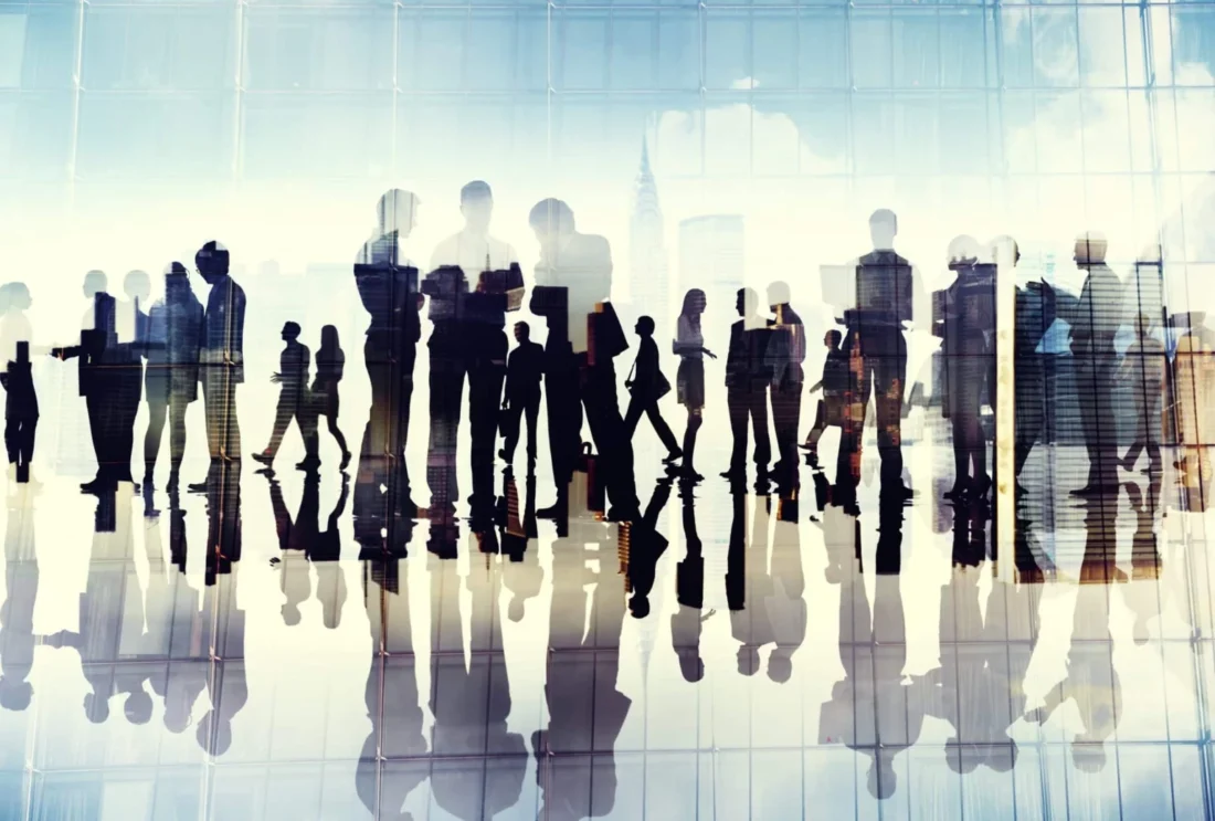 Silhouettes of business professionals networking, representing analyst relations for B2B tech companies.