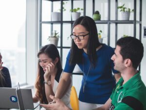 Team meeting discussing why AI recommends competitors over your company and how stronger public authority signals can improve B2B tech visibility.
