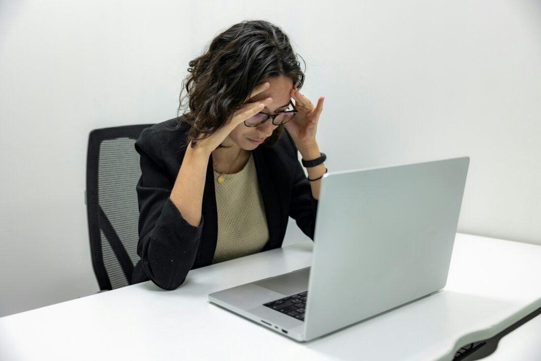 B2B technology executive reviewing her laptop and considering when to switch PR agencies.