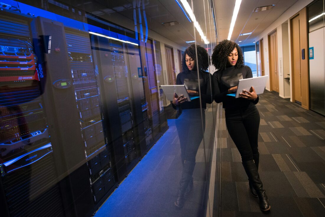 IT professional working beside server racks, representing specialized B2B tech public relations for complex technology companies.