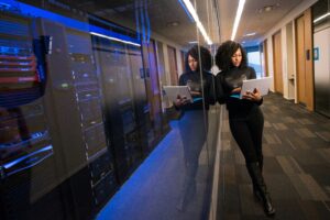 IT professional working beside server racks, representing specialized B2B tech public relations for complex technology companies.